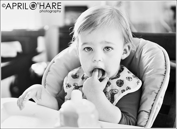 A natural photojournalistic B&W photo of a baby eating her lunch